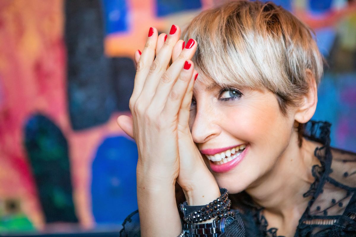 Virginie Vitcz laughing, colourful background
